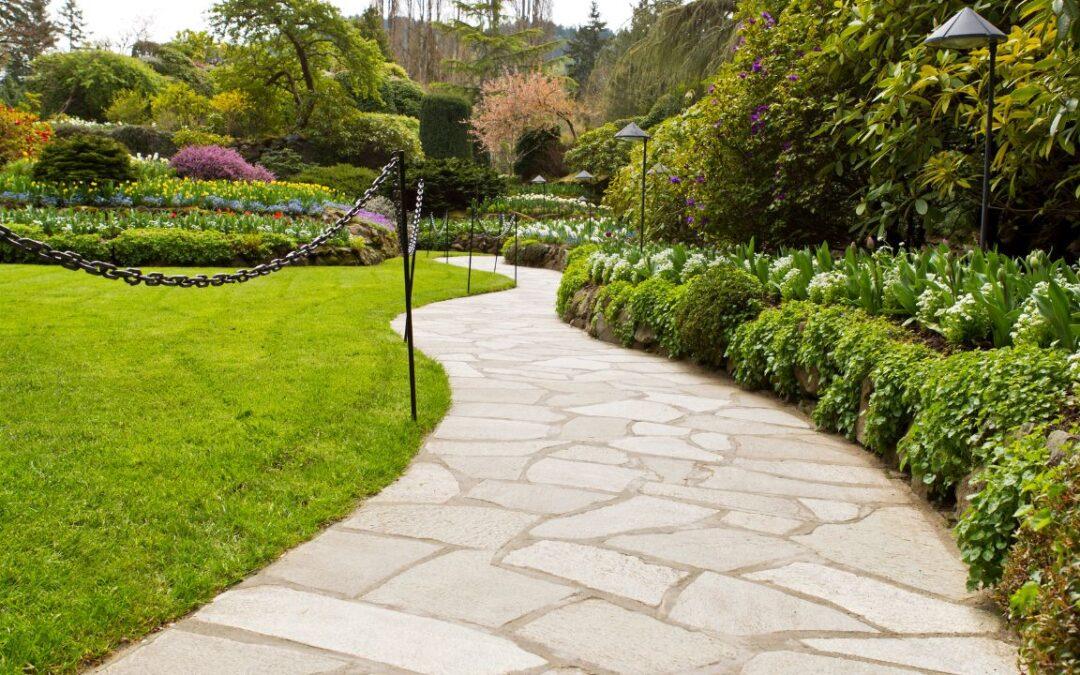 Elegant stone pathway winding through lush greenery, showcasing the beautiful outcome of careful planning and quality materials.