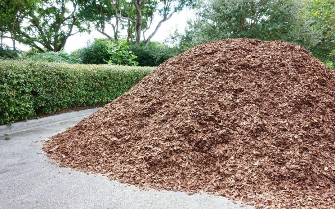 A McCarty Mulch & Stone delivery truck loaded with high-quality mulch, ready for convenient delivery to a landscaping project.